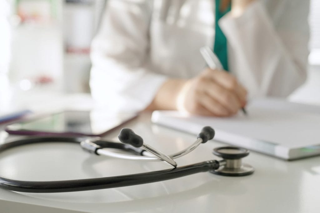 stethoscope laying on a doctors desk