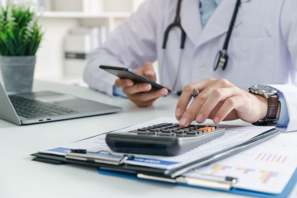 Doctor calculating cost of vasectomy